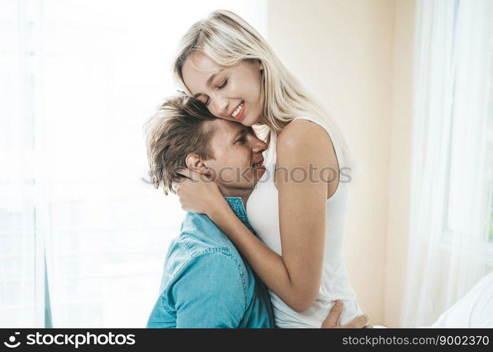 Happy Couple Playing together in the bedroom