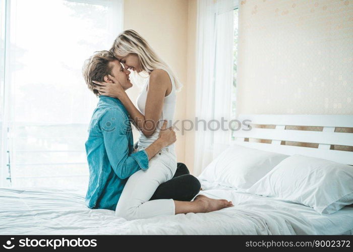 Happy Couple Playing together in the bedroom