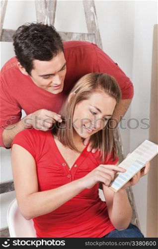 Happy couple pointing at color guide