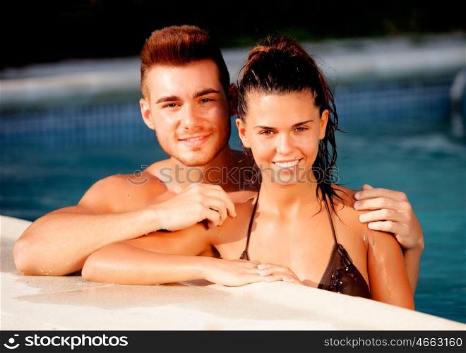 Happy couple relaxing in the pool in the summer