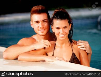 Happy couple relaxing in the pool in the summer