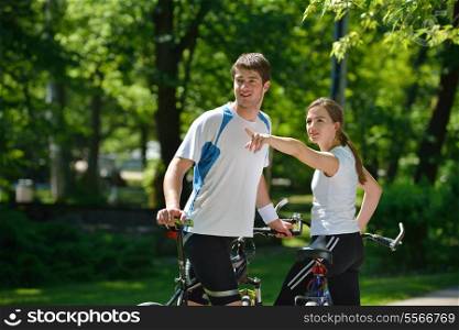 Happy couple ride bicycle outdoors, health lifestyle fun love romance concept