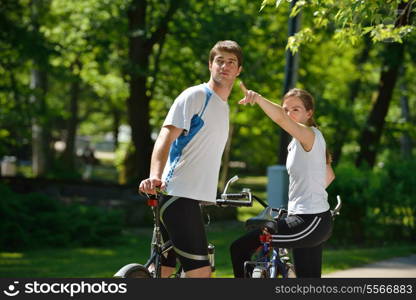 Happy couple ride bicycle outdoors, health lifestyle fun love romance concept