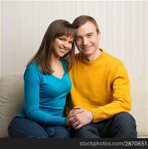 Happy couple sitting on sofa