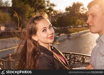Happy couple standing near river in summer