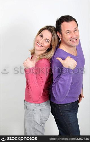 Happy couple standing on white background