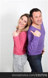 Happy couple standing on white background