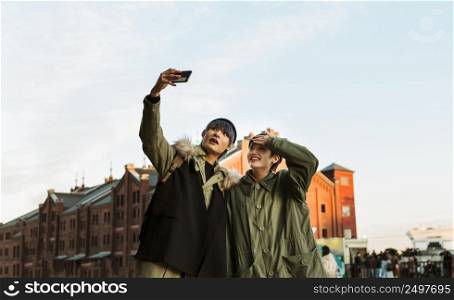 happy couple taking selfie medium shot 2