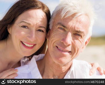 Happy couple together on the beach. Just us and the ocean