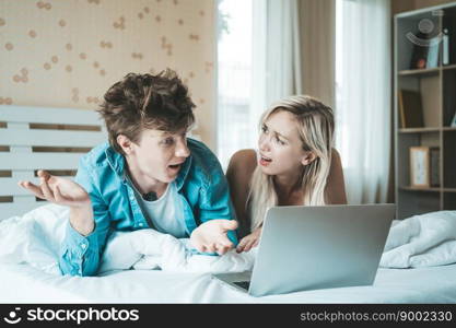 Happy couple Using laptop computer on the bed