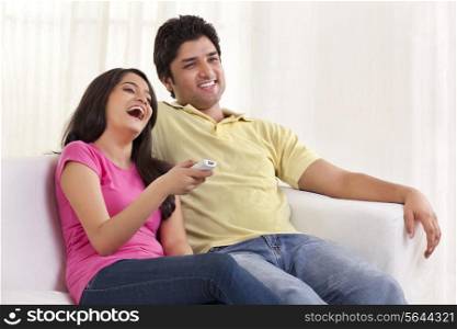 Happy couple watching TV