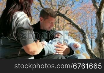 happy couple with a baby in her arms