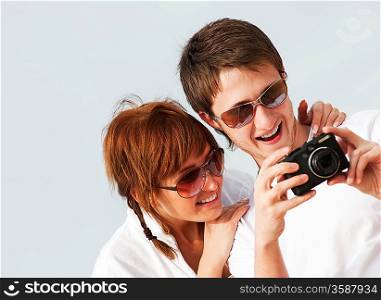 Happy couple with a digital camera