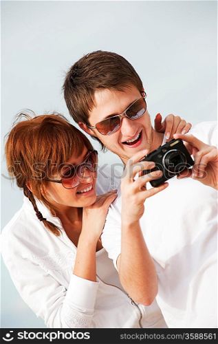 Happy couple with a digital camera