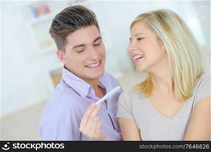 Happy couple with a pregnancy test