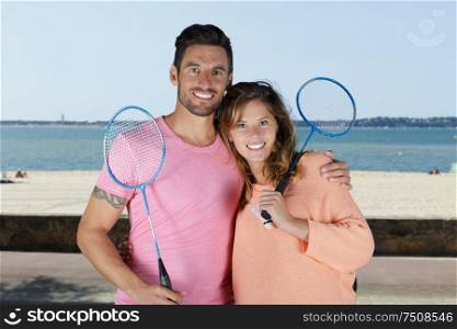 happy couple with badminton racquet and shuttlecock