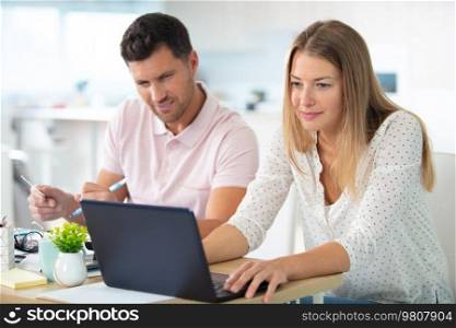 happy couple with laptop at home