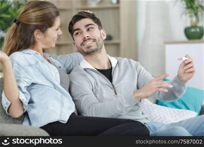 happy couple with pregnancy news