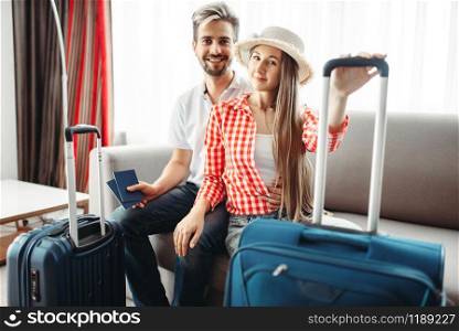 Happy couple with suitcases prepares for vacation. Fees on journey concept. Luggage preparation. Travelling or tourism. Happy couple with suitcases prepares for vacation