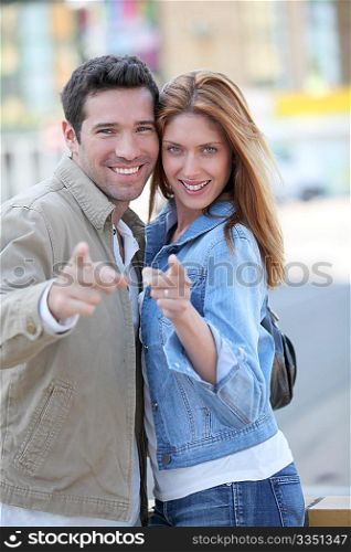 Happy couple with thumbs up in town