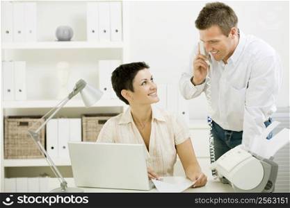 Happy couple working at home office running small business.