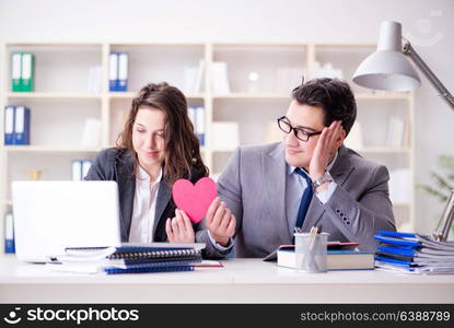 Happy couple working in the same office