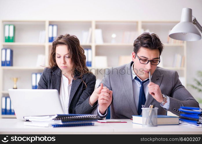 Happy couple working in the same office