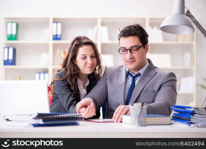 Happy couple working in the same office