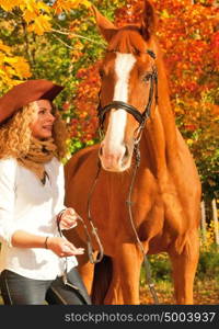 Happy cowgirl with her white horse.