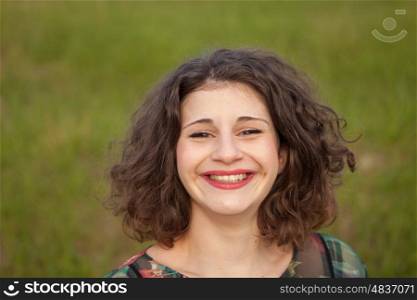 Happy curvy girl with curly hair in the landscape with a flowered dress