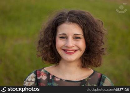 Happy curvy girl with curly hair in the landscape with a flowered dress