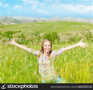 Happy cute girl on wheat field, smiling young lady enjoy open air, beautiful woman raised up hands, pretty teen playing outdoors, attractive female having fun outside, active life and freedom concept