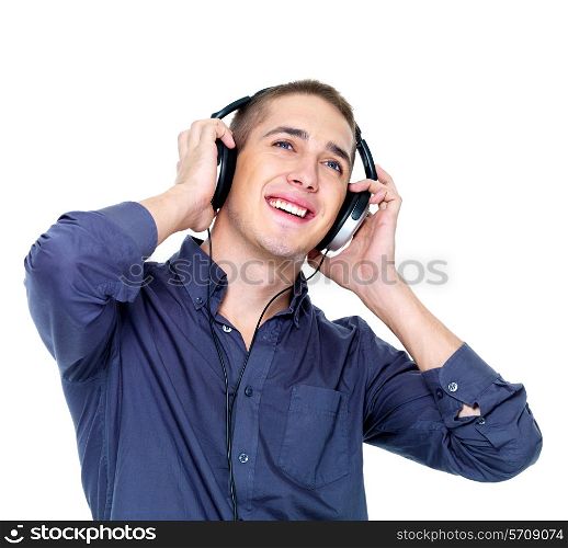 Happy dancing man with headphones looking up - isolated on white background