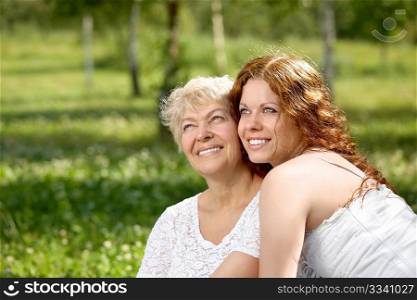 Happy daughter and mother in a summer garden