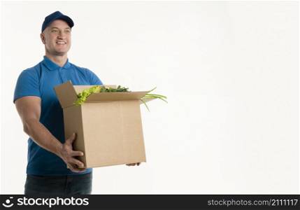 happy delivery man holding grocery box