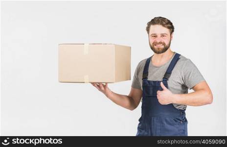 happy delivery man with box showing thumb up