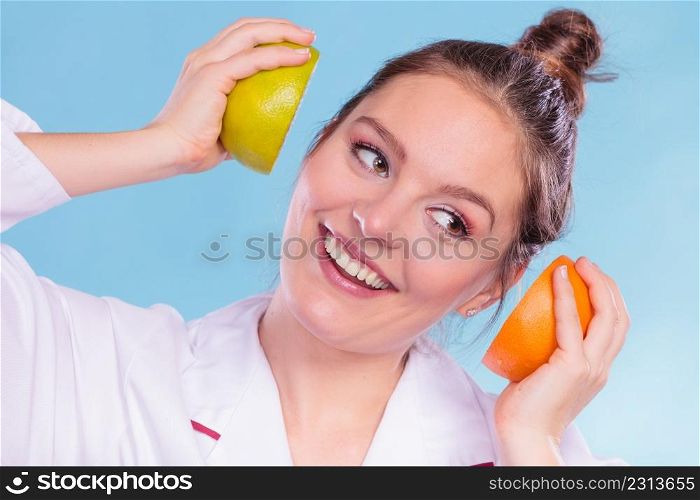 Happy dietitian nutritionist holding grapefruit having fun. Woman promoting healthy food fruit. Right eating nutrition and slimming concept.. Happy dietitian nutritionist with grapefruit.