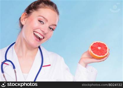 Happy dietitian nutritionist with grapefruit.. Happy dietitian nutritionist holding grapefruit. Woman promoting healthy food fruit. Right eating nutrition and slimming concept.