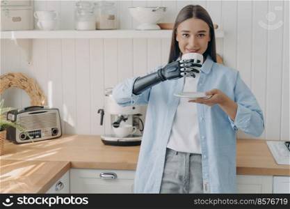 Happy disabled european woman is holding cup of coffee with cyber hand. Concept of grasp sensors in electronic high technology arm prosthesis. Routine of&utee person and life quality.. Happy disabled european woman is holding cup of coffee with cyber hand. Routine of&utee person.