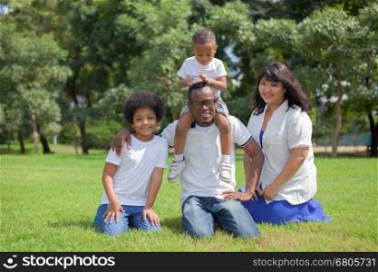 Happy diverse and mixed race family group photo in the park
