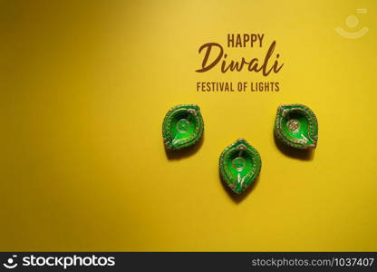 Happy Diwali - Clay Diya lamps lit during Dipavali, Hindu festival of lights celebration. Colorful traditional oil lamp diya