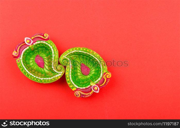 Happy Diwali Day, Flat lay top view Colorful Clay Diya lamps on red background and copy space for your text