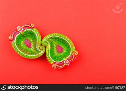 Happy Diwali Day, Flat lay top view Colorful Clay Diya lamps on red background and copy space for your text