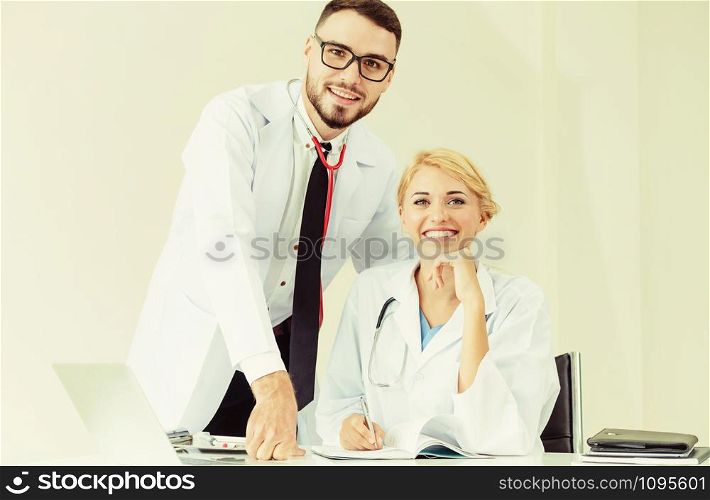 Happy doctor portrait at hospital office with another doctor that standing beside her. Medical people teamwork.