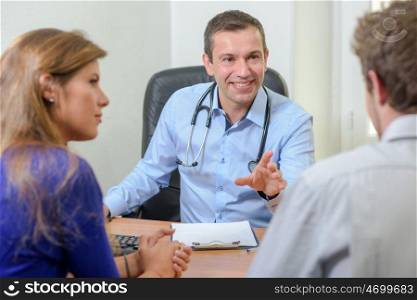 happy doctor talking to patients