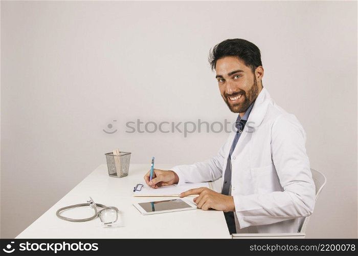 happy doctor with tablet office