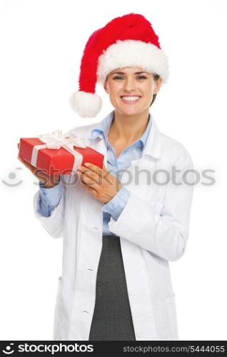 Happy doctor woman in santa hat holding christmas present box
