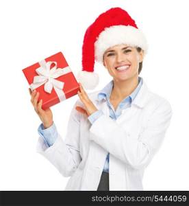 Happy doctor woman in santa hat showing christmas present box