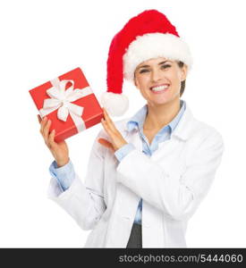 Happy doctor woman in santa hat showing christmas present box