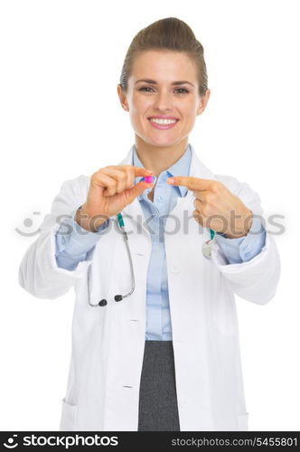 Happy doctor woman pointing on pill